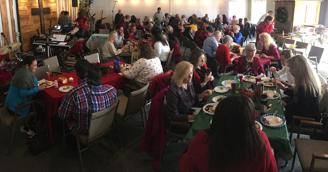 A Christmas gathering at The Well of Nashville, with the room set for a shared meal
